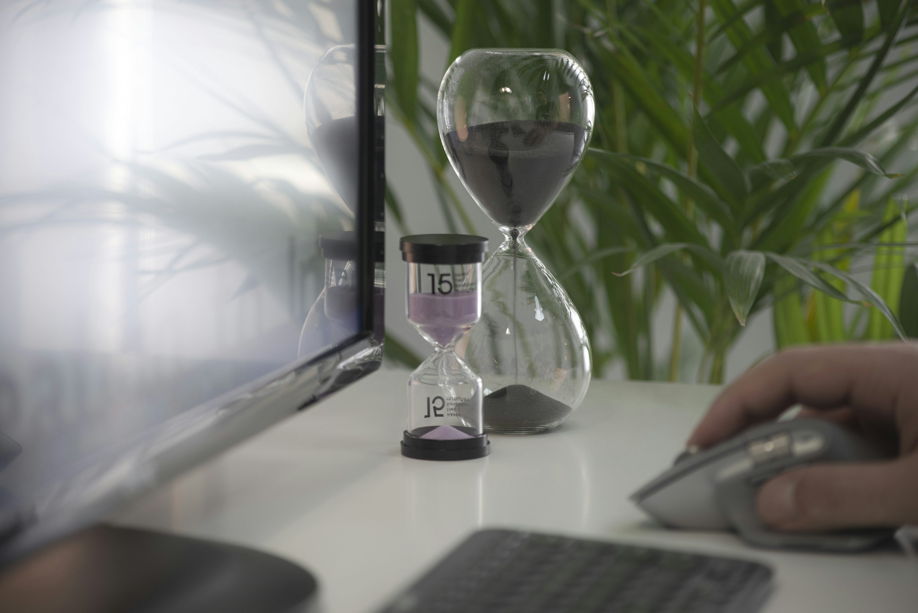 Hourglass with sand running down, ringed by clock numerals